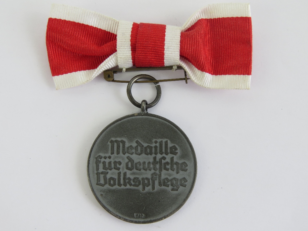 A WWII German Red Cross medal with ribbon. - Image 2 of 4