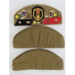 Three Russian side caps, one having number of badges upon.