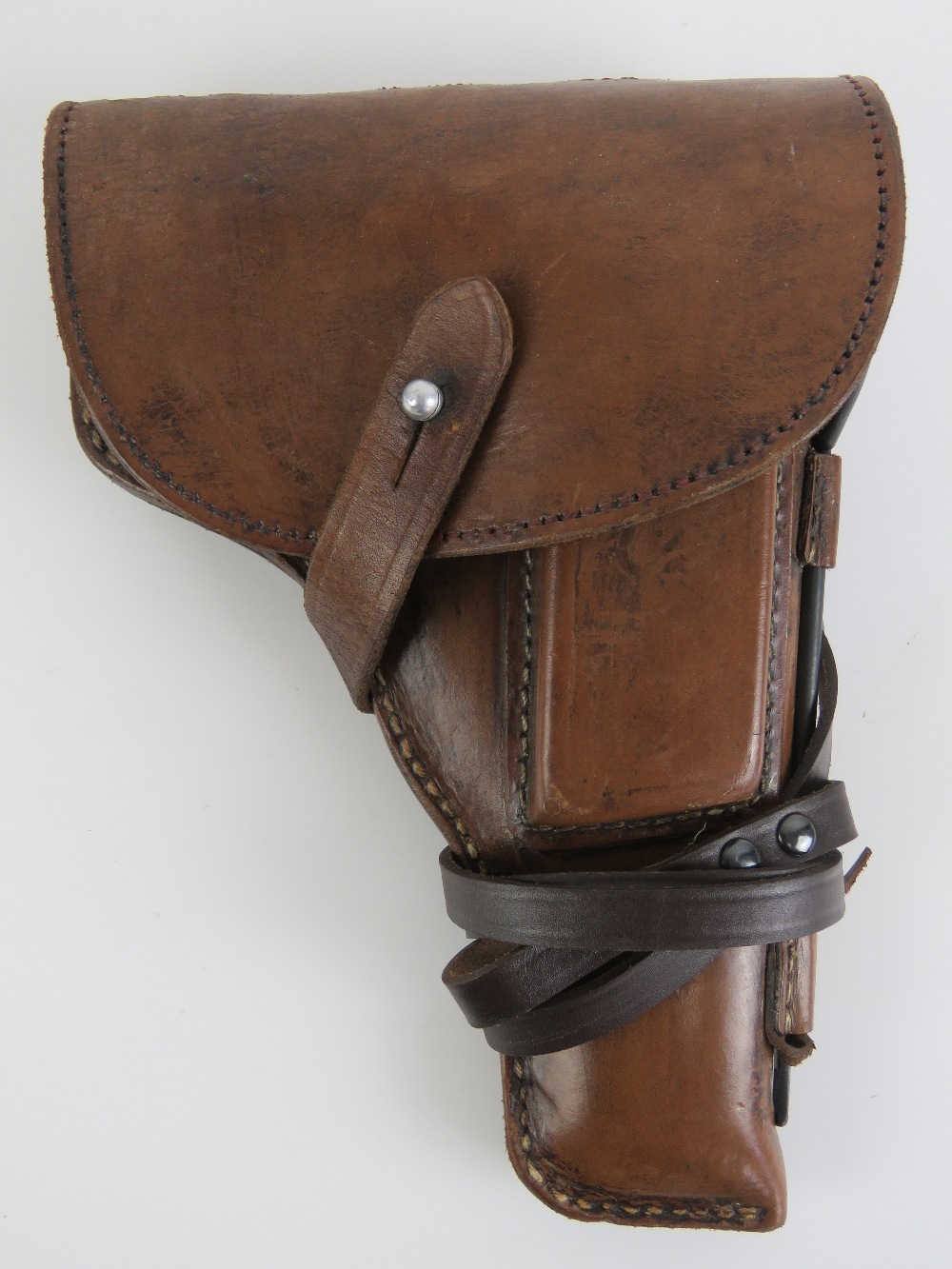 A WWII Tokarev TT33 leather holster with spare magazine, cleaning rod and lanyard.