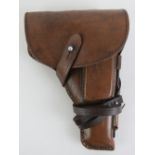 A WWII Tokarev TT33 leather holster with spare magazine, cleaning rod and lanyard.