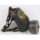 An early WWII German leather gas mask with filter.