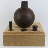 An inert WWI British 'Toffee Apple' bomb measuring 27.5cm high, with three fuses, on wooden plinth.