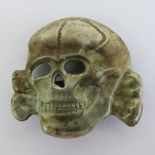 A WWII German SS Deaths Head Totenkopf cap badge.