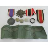 A quantity of assorted reproduction WWII German items including; SS ring, jacket buttons,