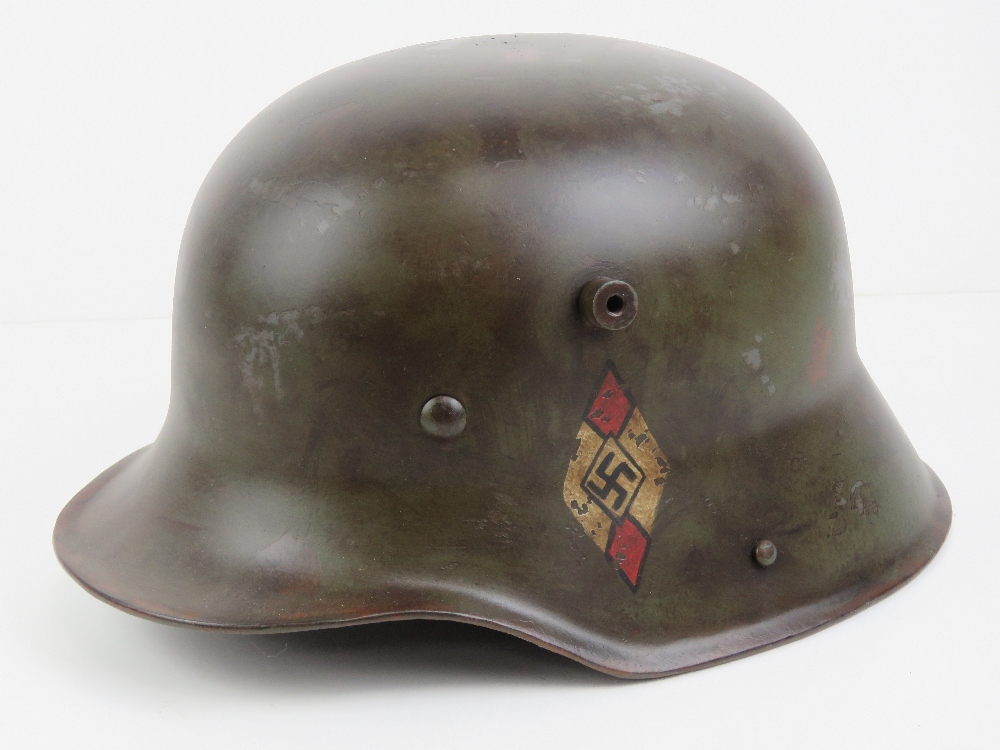 A WWI German M16 helmet with liner having later transitional Hitler Youth leaders decals upon.
