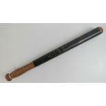 A Victorian truncheon having black groun