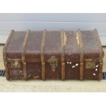 A vintage steamer trunk with leather end