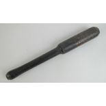 A Victorian truncheon having black groun