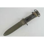 A WWII US M1 Carbine bayonet with scabbard.
