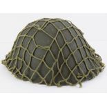 A WWII British 'tortoiseshell' helmet with netting, liner and strap.