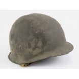 A WWII US Army helmet, marked 1209D within.