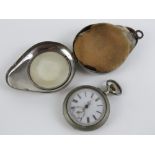 A vintage pocket watch having white enamel dial and rose metal hands,