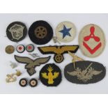 A quantity of assorted military cloth patches with two cockade badges, pin badge, etc.