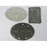 Two German dog tags together with a pressed metal plaque of a German soldier. Three items.