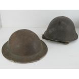 Two WWII British Army helmets.