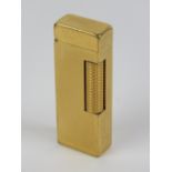 A gold plated Dunhill lighter; mid-late 20th century collectors Rollalite gas fueled flint lighter,