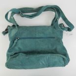 A vintage turquoise blue suede handbag.