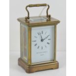 A Matthew Norman five glass brass carriage clock having swing handle over, with key.