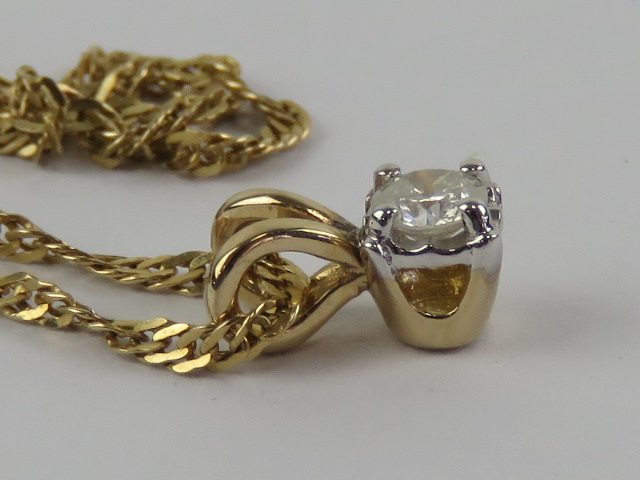 A solitaire diamond pendant, claw set in white white metal on yellow metal, measuring 0. - Image 2 of 3