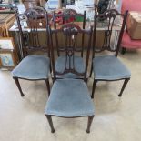 A set of four mahogany Edwardian high back dining chairs.
