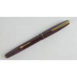 A vintage Watermans 'self-filler' fountain pen with original 14ct gold nib.