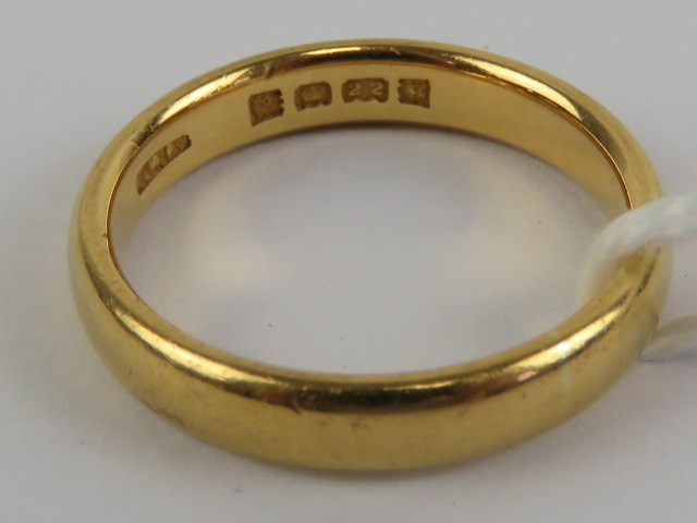 A 22ct gold D-shaped plain band, hallmarked London, size P, 6.