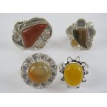 Four hardstone rings each stamped 925, size R-S, including goldstone.
