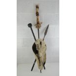 An African animal skin shield with spear, cane and club, 126cm high.