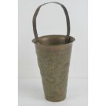 An Oriental brass brush pot having handle over, embossed four toed Dragon and foliage upon,