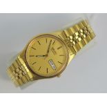 A gold plated Seiko with day and date aperture, yellow metal hands and batons,