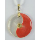 A 24ct gold mother of pearl and red jade disc pendant, bale stamped 24k, 2.5cm dia.