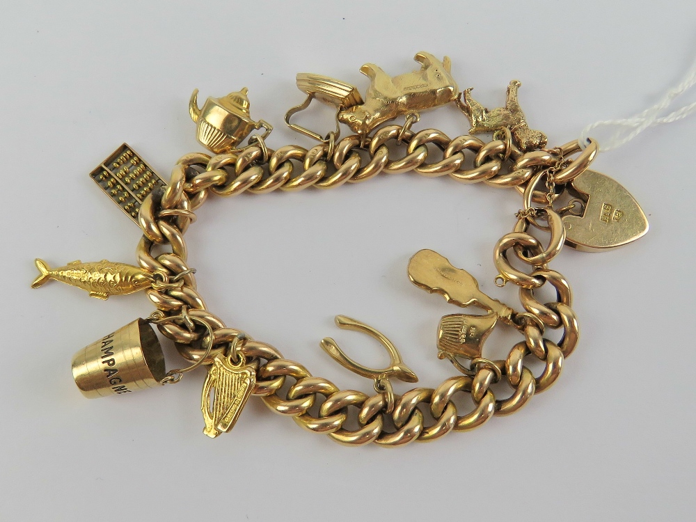 A 15ct gold charm bracelet having heart padlock clasp, stamped 15,