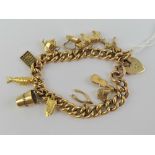 A 15ct gold charm bracelet having heart padlock clasp, stamped 15,