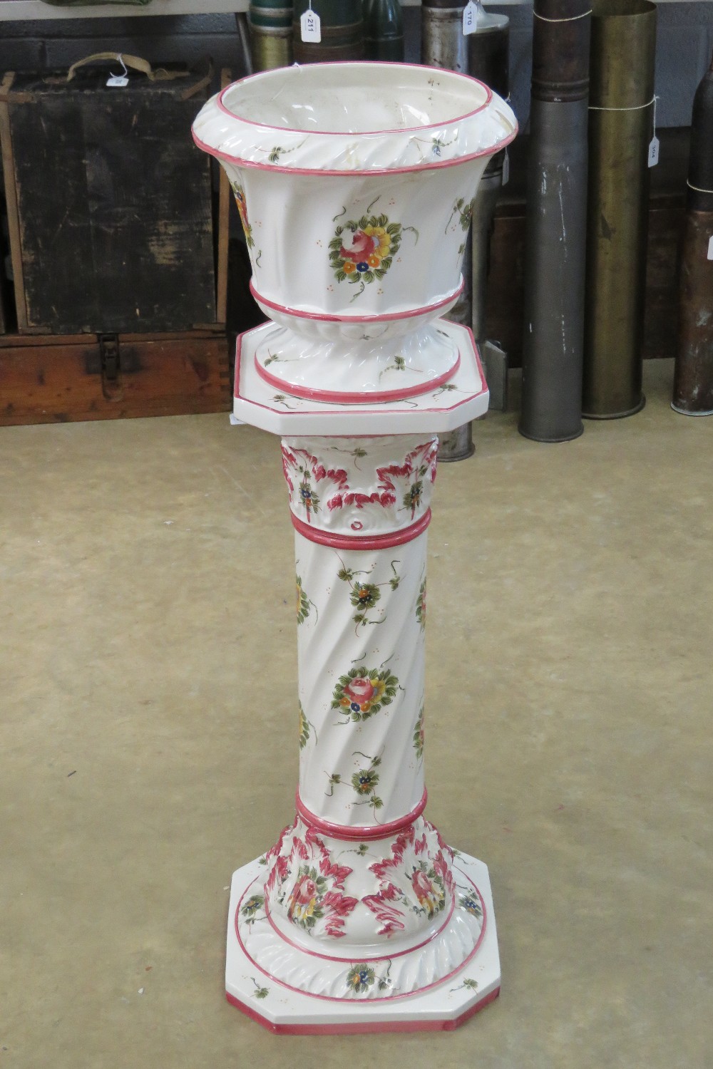 A Capodimonte planter on stand, in three sections, white ground with floral pattern upon,