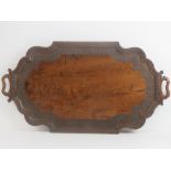 A good decorative oak shaped tray, blind carved foliate decoration and integral end handles,