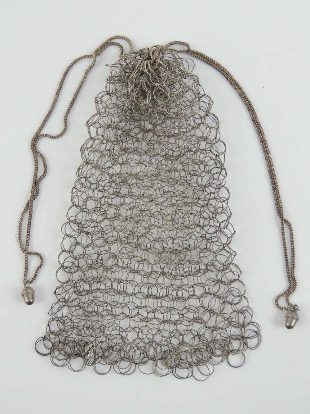 A delightful vintage metal chain link ladies purse having chain drawstring with acorn finials.