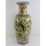 A 20th century Oriental export oversize shoulder vase in yellow ground decorated with mythical