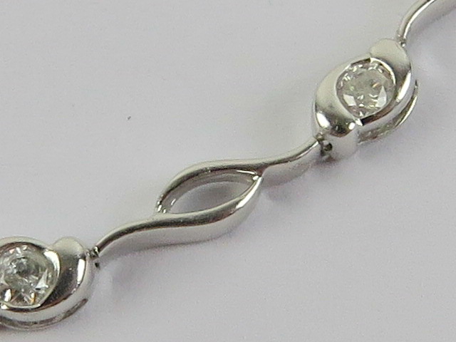 A 9ct white gold and diamond bracelet, each of the eleven diamond in rubover setting, - Image 2 of 3