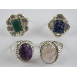 Four hardstone rings each stamped 925, size T-V, including rose quartz and lapis lazuli.