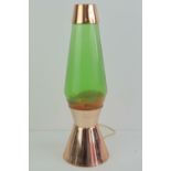 A vintage Astro style orange lava lamp having copper top and stand, for re-wiring.