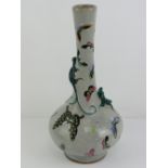 An Oriental grey crackle glazed bottle vase having applied lizard decoration upon and handpainted