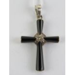 A silver and onyx crucifix having marcasites upon, stamped 925, 4.7cm in length inc bale.