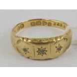 An 18ct gold Gypsy ring having three star set diamonds, hallmarked Chester, size N, 2.1g.