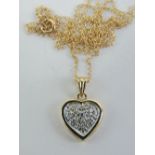 A 9ct gold pendant having central white metal heart set with diamonds, yellow metal surround,