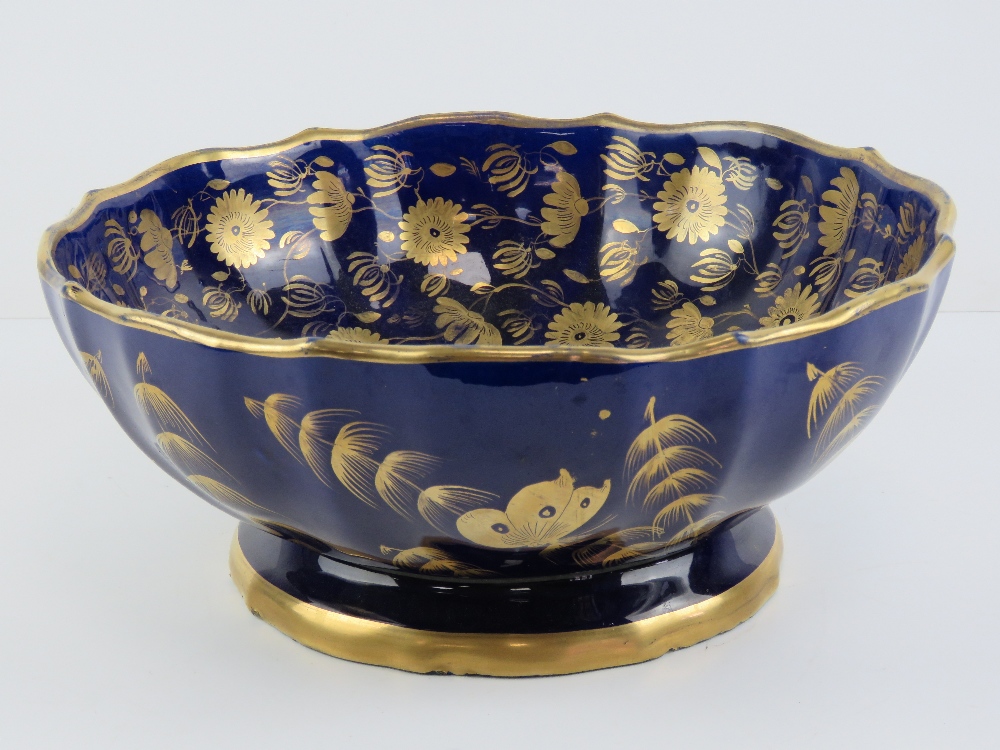 A 19th century cobalt blue and gilded pedestal bowl having floral decoration throughout,