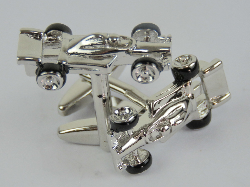 A pair of 'as new' cufflinks in the form of F1 racing cars, in presentation box.