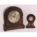 An Edwardian inlaid balloon clock having Arabic numerals before the clockwork movement, 17cm high.