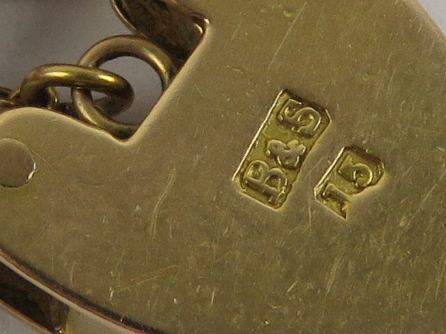 A 15ct gold charm bracelet having heart padlock clasp, stamped 15, - Image 2 of 3