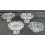 Four assorted pressed glass cake stands.