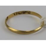 An 18ct gold plain band, hallmarked Chester, size N, 0.7g.
